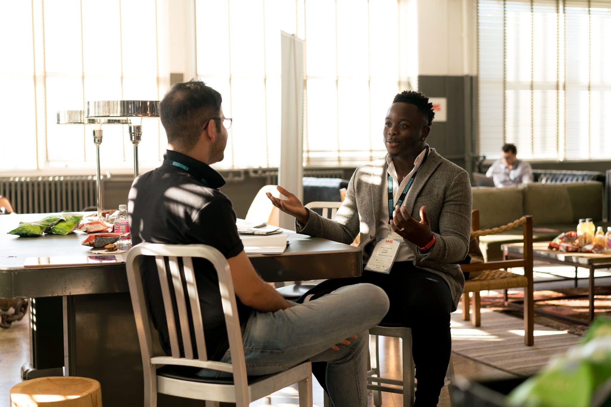 Two people sitting and facing each other, talking