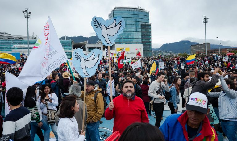 A peace rally in Colombia with colorful signs and banners 